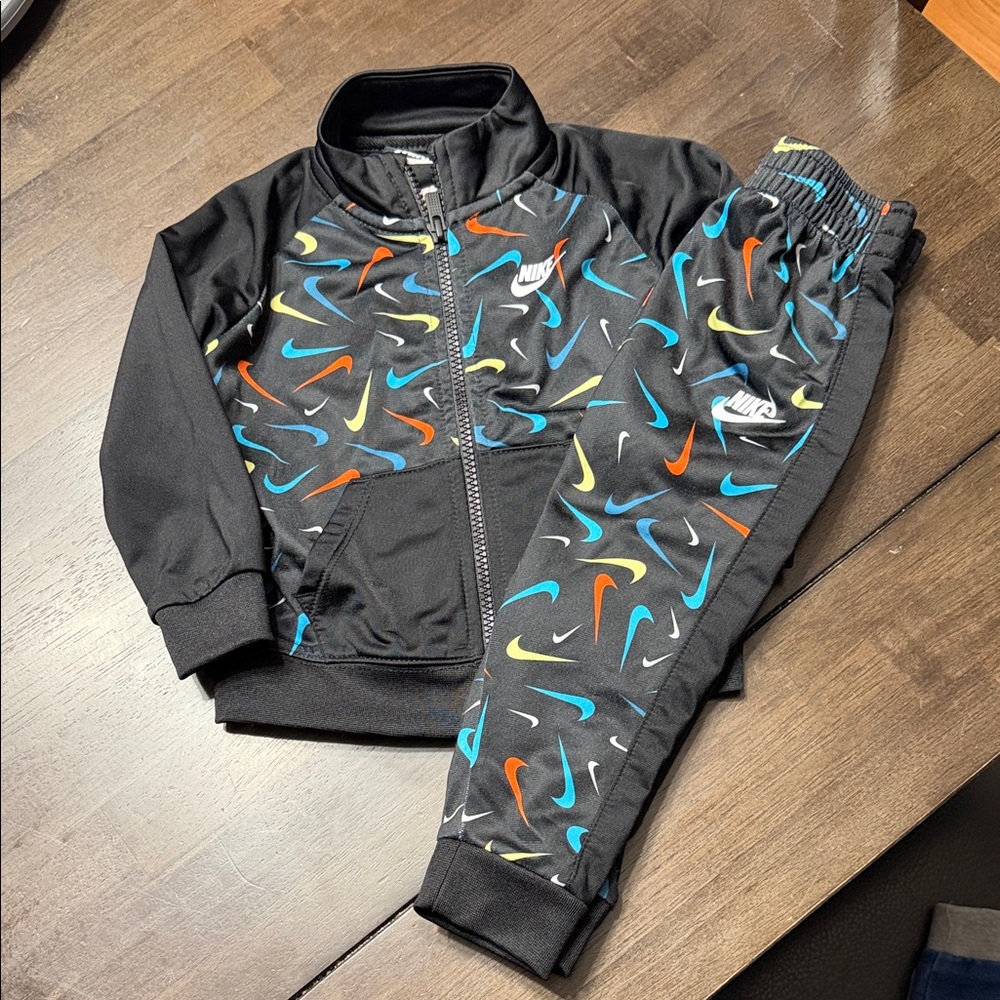 Nike Kids' Black Tracksuit with Vibrant Swooshes